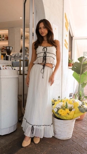 Detail of white two-piece summer set with ruched tube top and long flowing skirt
