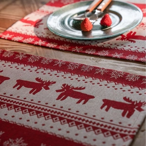 Christmas reindeer jacquard placemats with red and beige knit snowflake patterns