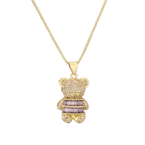 Detail of teddy bear pendant with purple gemstones and crystals on golden chain