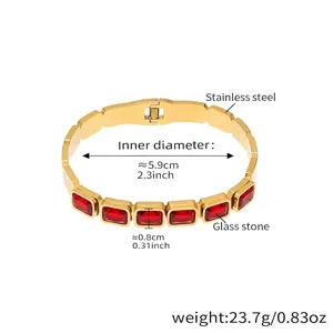 Detailed view of gold stainless steel bangle with red glass stones and size measurements