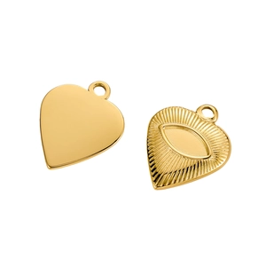 Detail of golden stainless steel heart charms featuring an embossed evil eye design