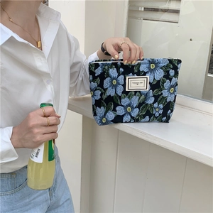 Detailed texture of blue floral jacquard fabric on small tote with Pleasant Time label