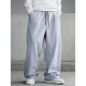 Close-up of drawstring waist and grey cotton fabric on loose men's sweatpants