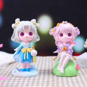 Macro shot of two resin Capybara dolls in colorful outfits on a car dashboard