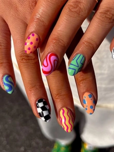 Close-up of vibrant oval press-on nails with colorful geometric patterns and wavy lines