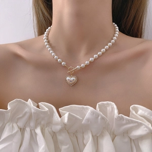 Elegant pearl heart necklace with gold toggle clasp and shimmering shell pendant