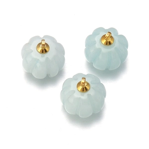 Detailed view of light blue pumpkin-shaped stone pendants with gold metal clasps