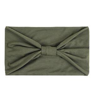 Detail of army green knitted headband with center pleat design on white background