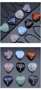 Macro shot of assorted heart-shaped natural stone necklaces with tree of life wire wrap