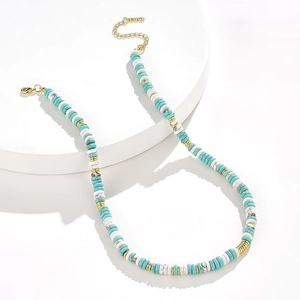 Detail of bohemian necklace showing turquoise beads and golden lobster clasp closure