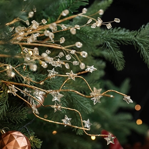 Golden Christmas tree branches with sparkling crystal stars and beads for holiday decor