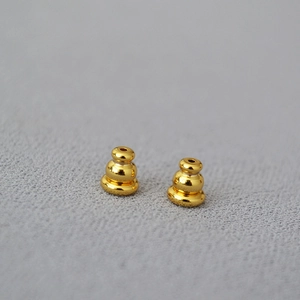 Close-up of gold-plated brass bullet earring backs with anti-slip silicone core