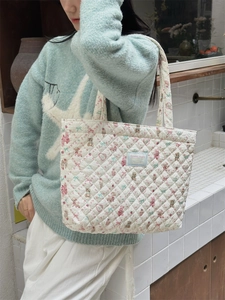 Quilted cotton tote bag with bear and floral print shown with a casual model