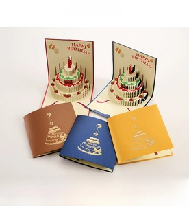 Detail of 3D pop-up birthday card with multi-layer cake design and gold foil patterns