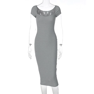 Detail of grey ribbed knit dress featuring a sheer mesh insert at the neckline