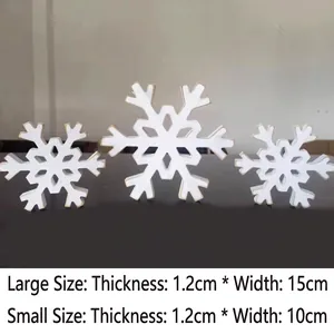Set of two white wooden snowflake table ornaments in 10cm and 15cm sizes for Christmas