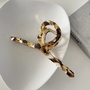 Detail of 13cm tortoiseshell acetate hair claw clip with golden metal spring mechanism