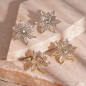 Luxe silver and gold snowflake flower stud earrings with sparkling cubic zirconia crystals