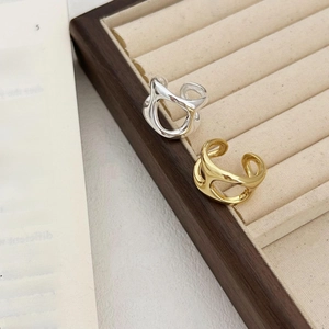 Irregular 925 sterling silver open rings in gold and silver finish on a jewelry box