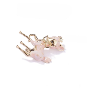 Detail of pink enamel deer brooch with gold-tone crown and bow tie accessories