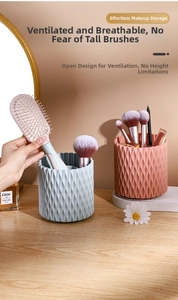 Close-up of dual-color rotating makeup brush holders with textured geometric diamond pattern