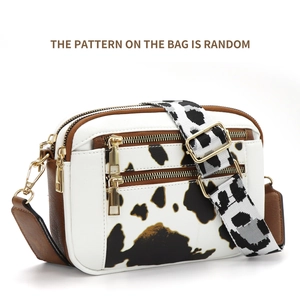 Crossbody camera bag with cow print pattern, multi-zipper pockets and wide knit strap