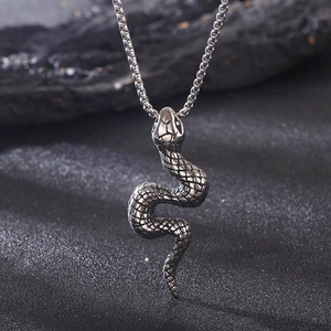 Macro shot of silver snake pendant with scale texture on a punk rock style chain