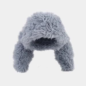 Close-up of light grey plush faux fur texture on a winter trapper hat for women