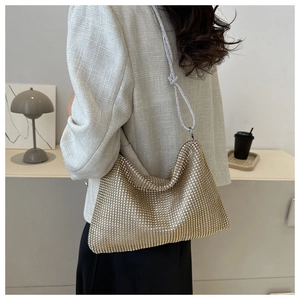 Detail of the golden rhinestone hobo bag showing the sparkling crystal mesh and knotted strap