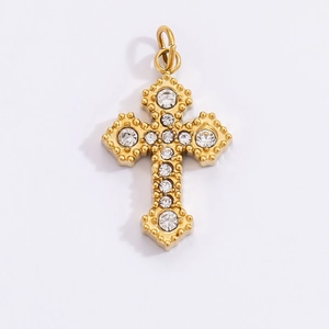 Macro shot of gold-plated stainless steel cross pendant with sparkling clear zircons