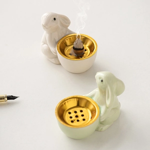 Ceramic bunny incense burners in white and light green with elegant gold trays