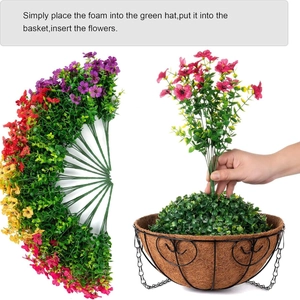 Artificial violet flowers in hanging coconut liner basket with metal frame and foam base