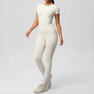 Detail of high-stretch beige yoga set with fitted short sleeve top and leggings