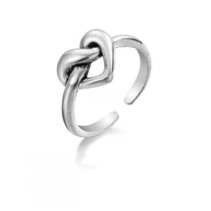 Macro shot of 2.5g vintage silver heart knot alloy ring with adjustable open band detail