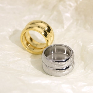 Macro detail of gold and silver double-layered polished titanium steel wide band rings