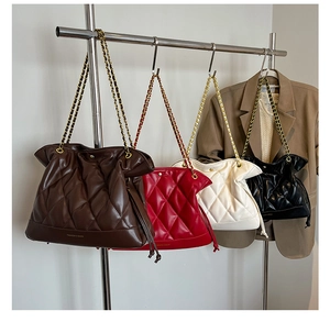 Quilted leather tote bags in brown, red, white, and black with gold chain straps