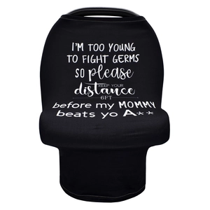 Detail of black car seat cover with white typography slogan I'M TOO YOUNG TO FIGHT GERMS