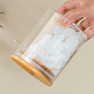 Borosilicate glass storage jar with bamboo lid and spoon filled with white sugar cubes