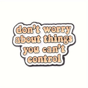 Macro detail of enamel brooch with slogan don't worry about things you can't control