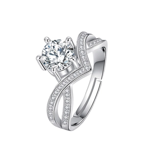Macro detail of silver six-prong moissanite ring with a unique criss-cross pave band