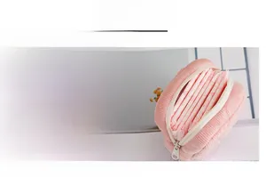 Detailed shot of pink corduroy sanitary bag with smooth zipper and interior storage space
