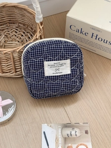 Navy blue checkered heart quilted storage pouch with a zip closure and soft fabric texture