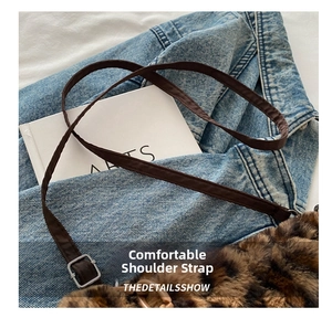 Close-up of leopard faux fur shoulder bag with adjustable brown strap and silver buckle