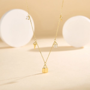 Elegant gold S925 silver necklace featuring sparkling zircon lock and key tassel charms