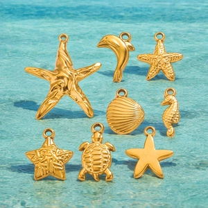 Set of 8 golden stainless steel ocean charms including starfish and shells on blue water background