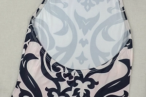 Detail of baroque scroll print fabric and fine stitching on a halter jumpsuit neckline