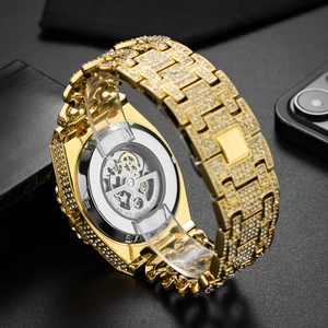 Iced out gold automatic watch with skeleton dial and diamond-encrusted cuban link band