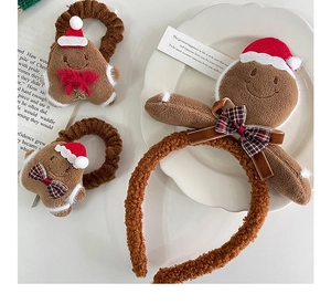Detail of plush gingerbread man Christmas headband and hair ties set in brown and red