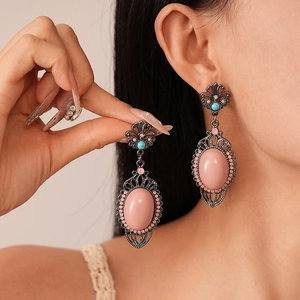 Vintage bohemian drop earrings with pink oval stones and silver floral engraving