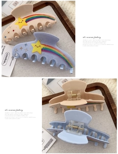 Detail view of star and rainbow claw clips with sparkling rhinestones in light blue and beige
